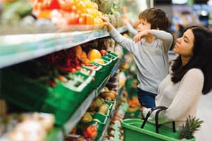 mom and kid grocery shopping